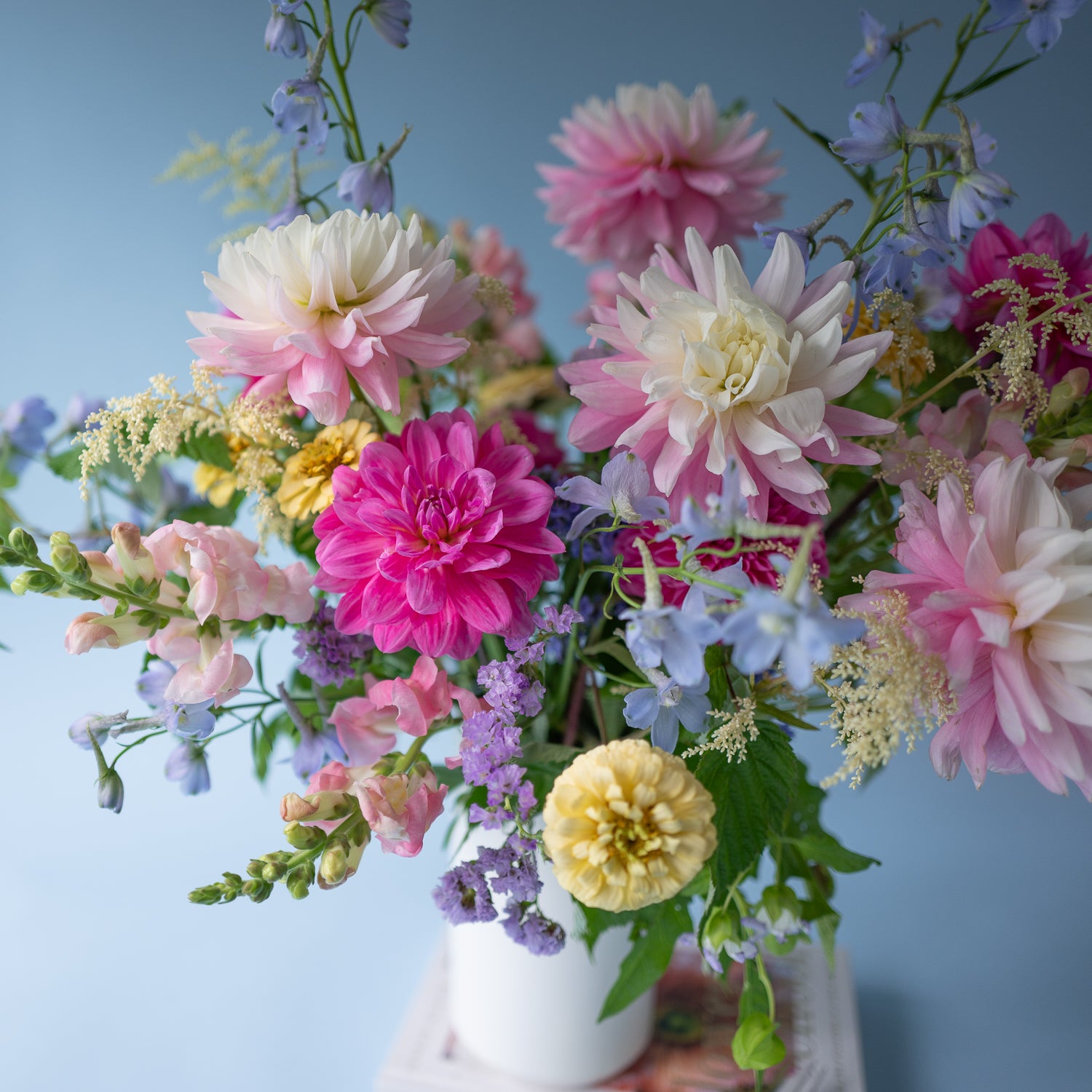Love in a Mist flower arrangement designed in a stylish, white ceramic vase. Available for local delivery throughout Portland, Oregon