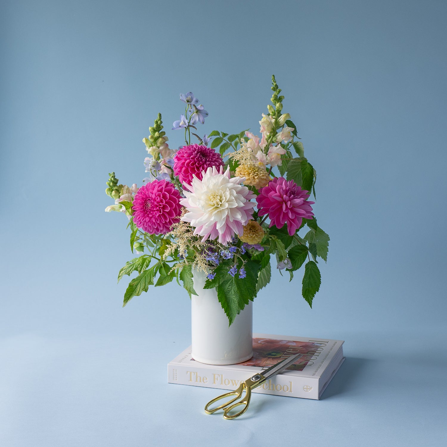 Love in a Mist standard flower arrangement designed in a stylish, white ceramic vase. Available for local delivery throughout Portland, Oregon