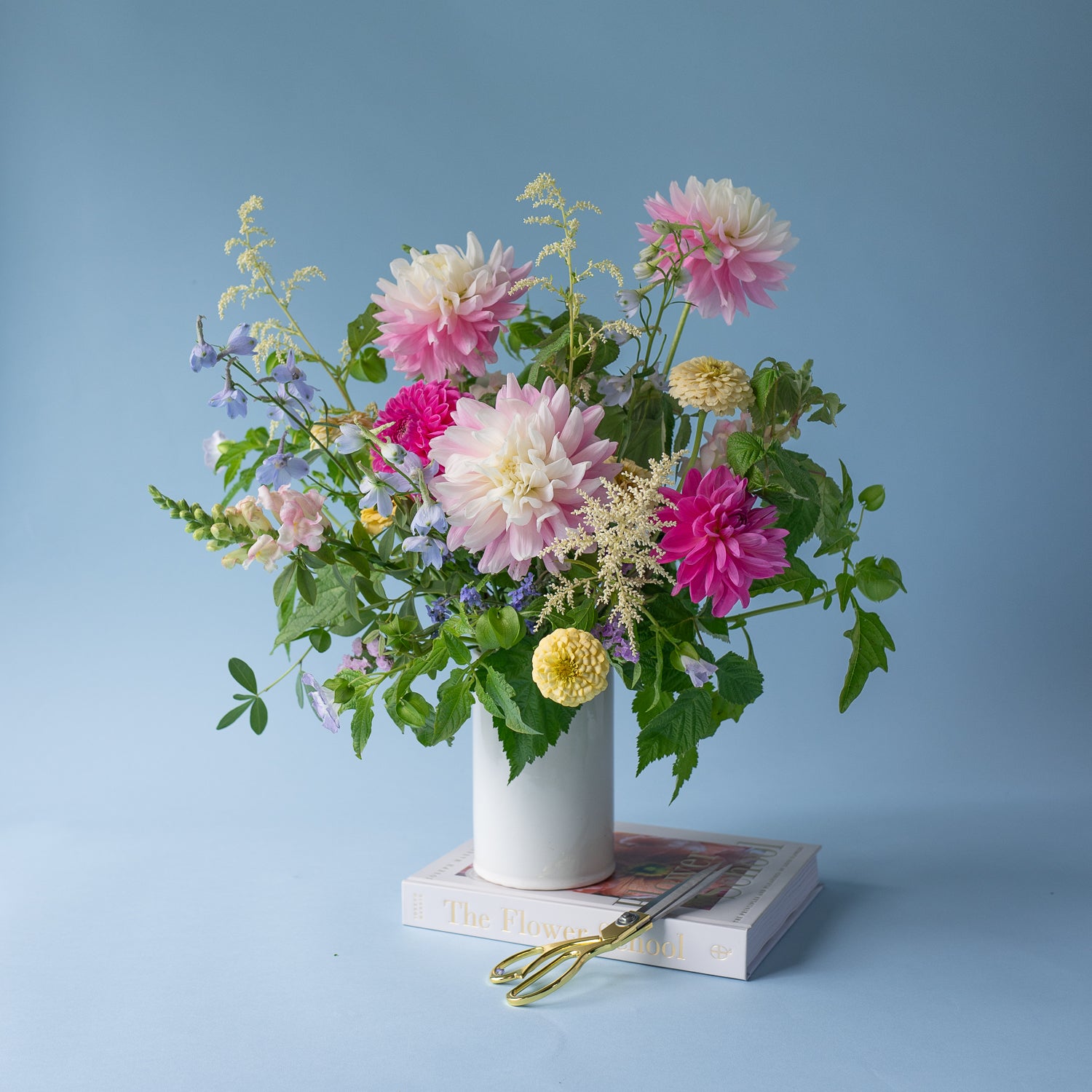 Love in a Mist deluxe flower arrangement designed in a stylish, white ceramic vase. Available for local delivery throughout Portland, Oregon